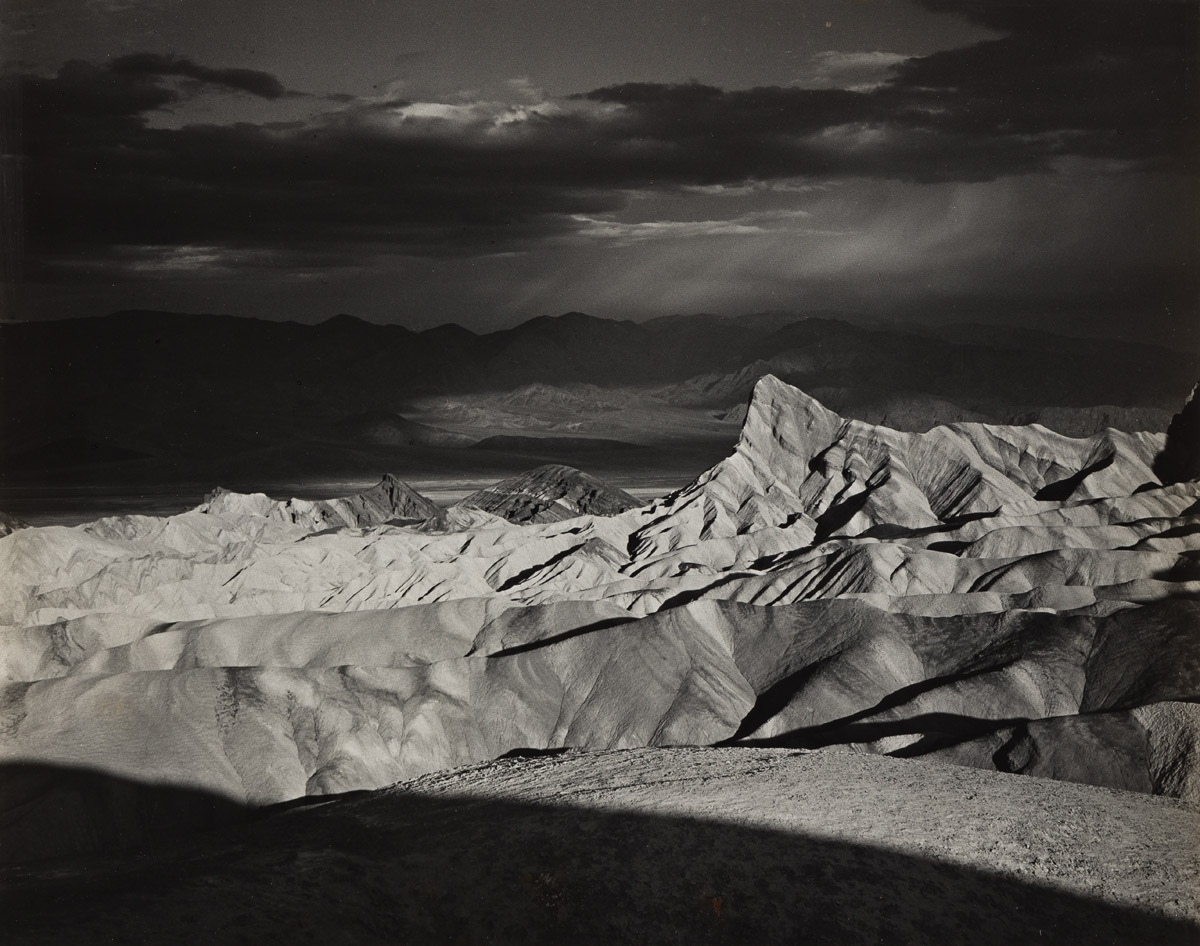 ANSEL ADAMS (1902-1984) Manly Beacon from Zabriskie Point, Storm, Death Valley National Monument, California.